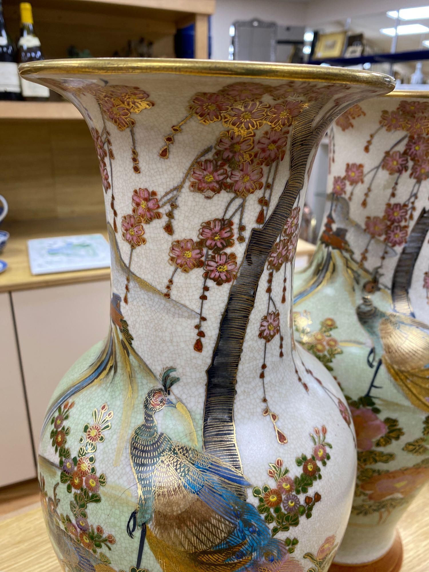 A pair of Japanese satsuma baluster vases, height 46cm, and a satsuma bulbous vase, height 37cm